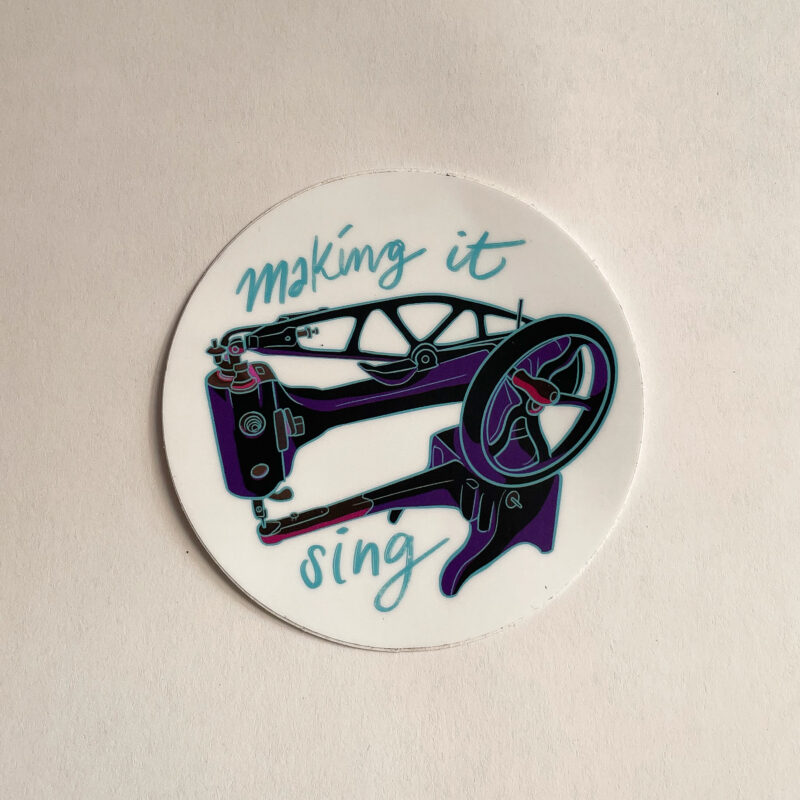Sticker of a Singer 29k Sewing machine surrounded by "Making it Sing"