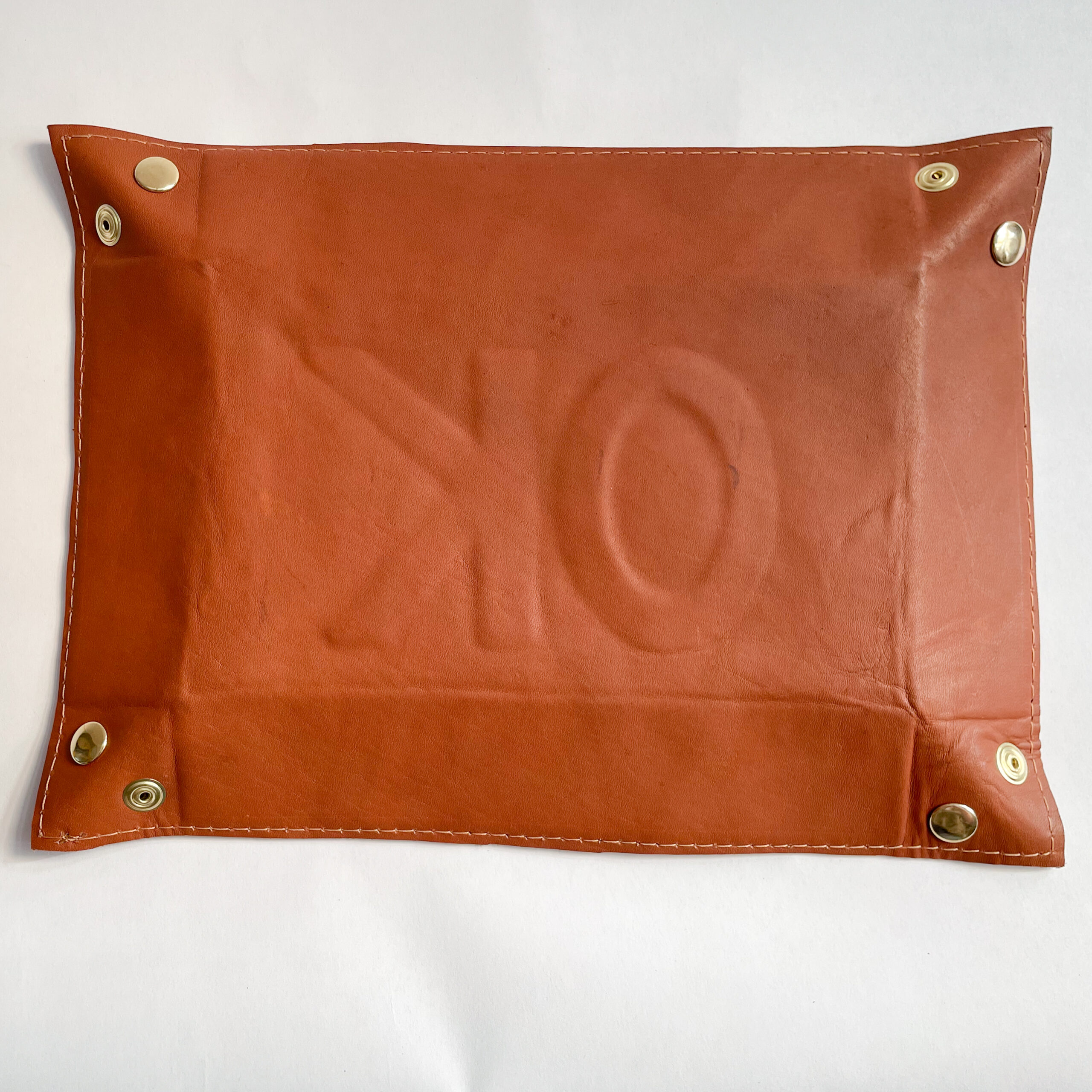 The backside of a OK Valet Tray, with a slight "OK" imprint.