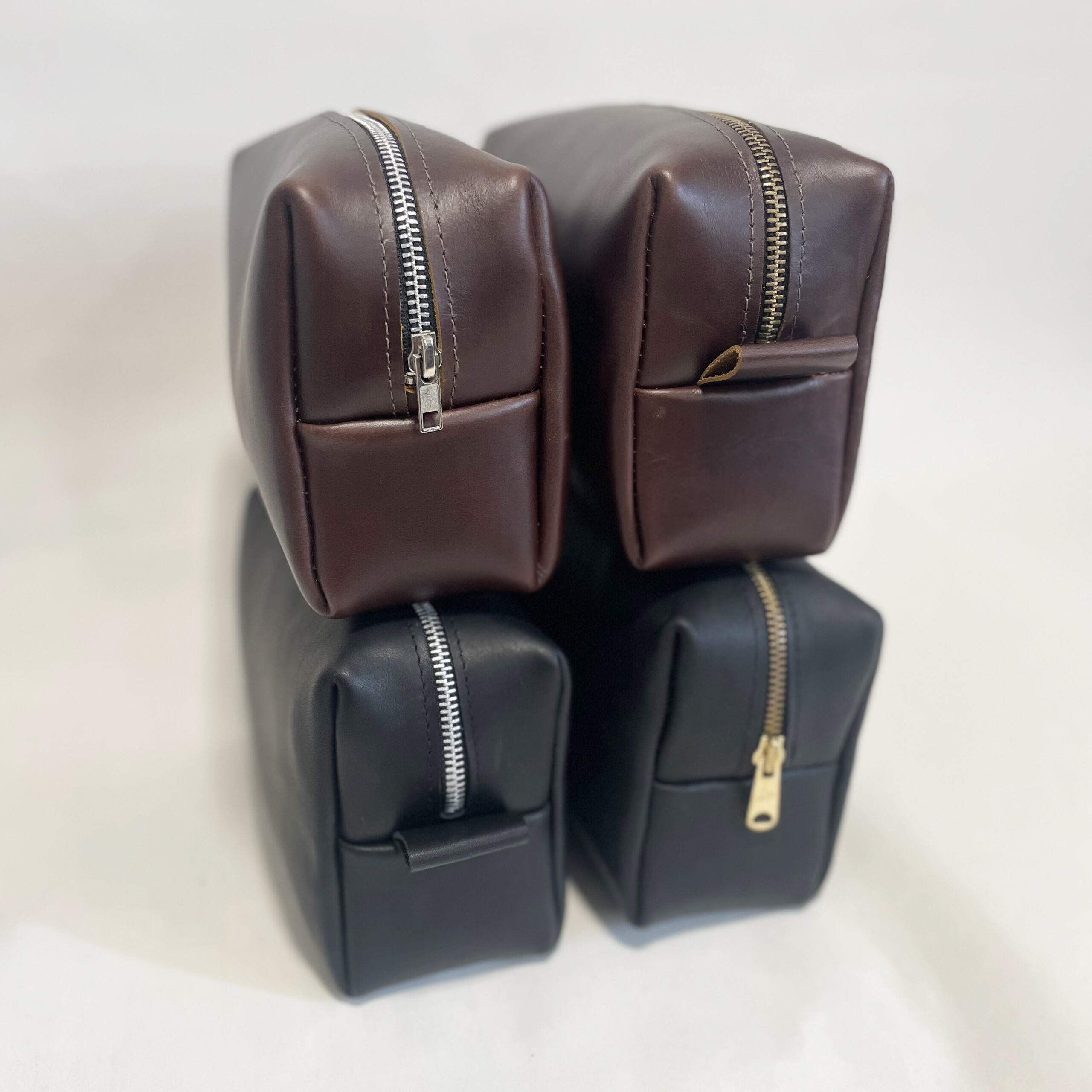 Four leather dopp kits